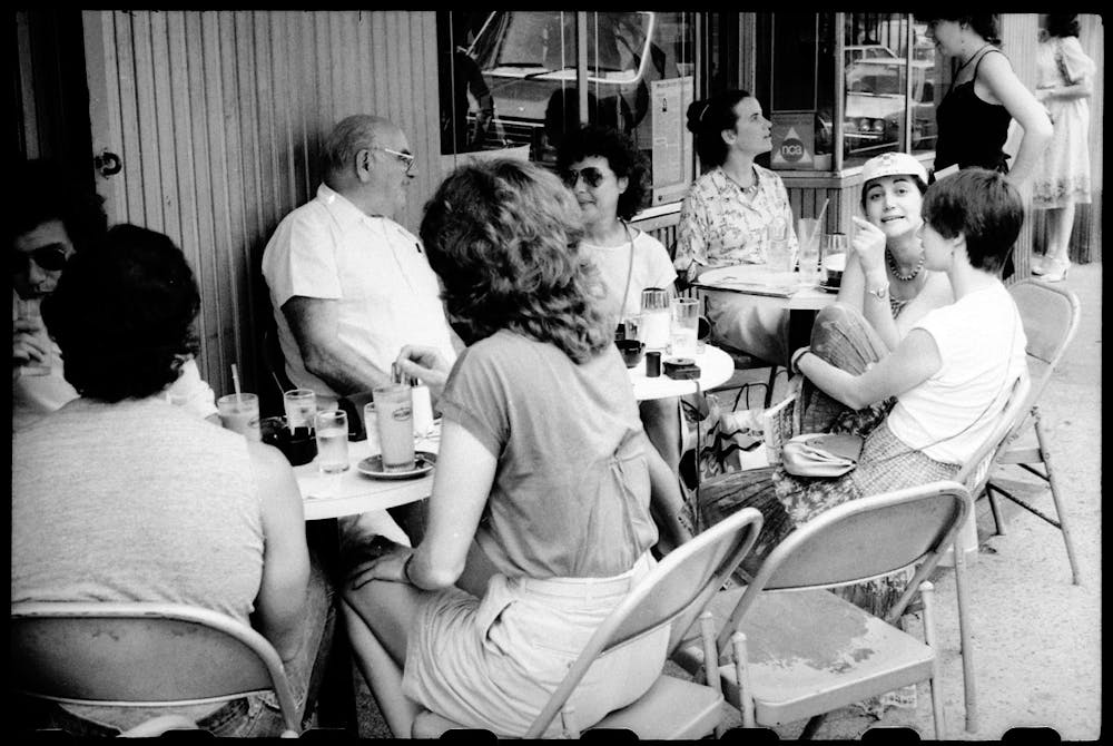 Martha Argerich et al. sitting in a chair talking on the phone