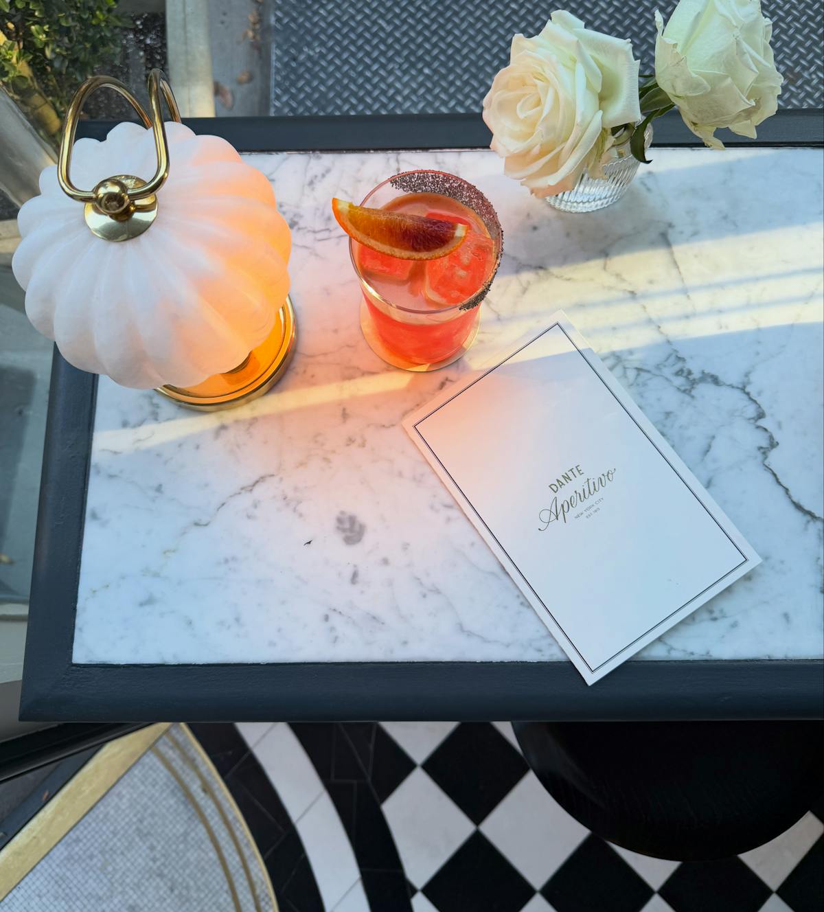 a cocktail and menu on a table