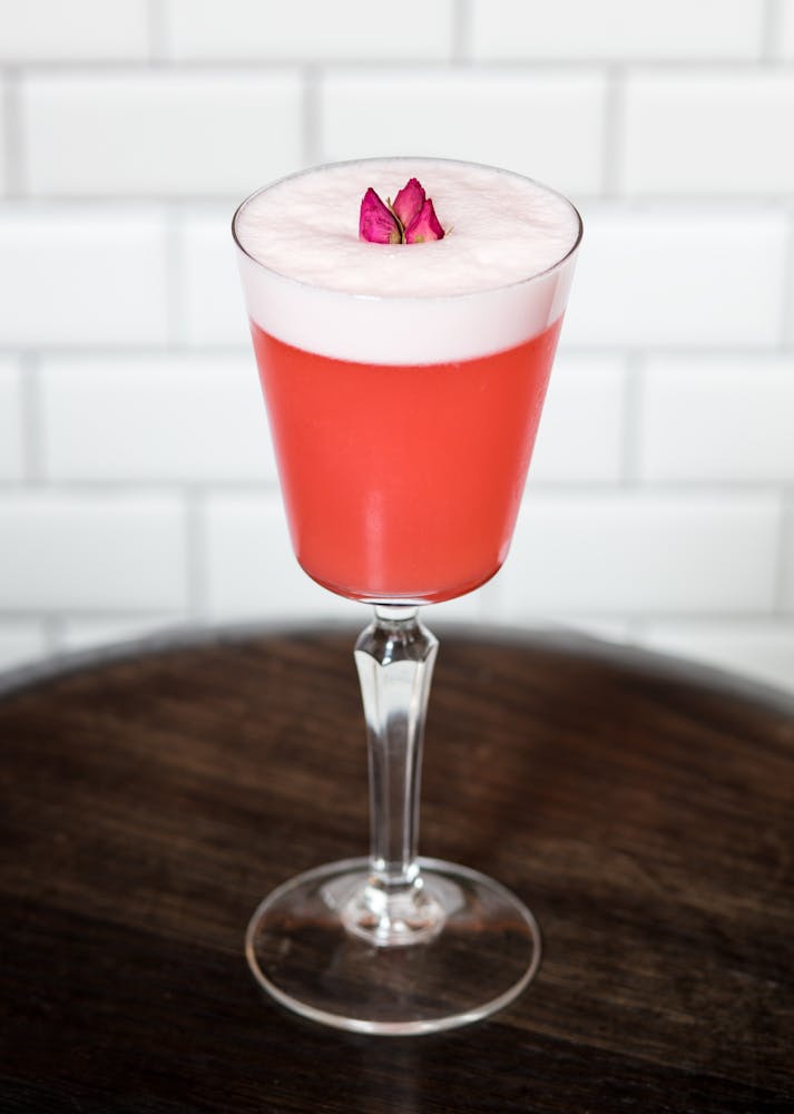 a close up of a wine glass sitting on a table
