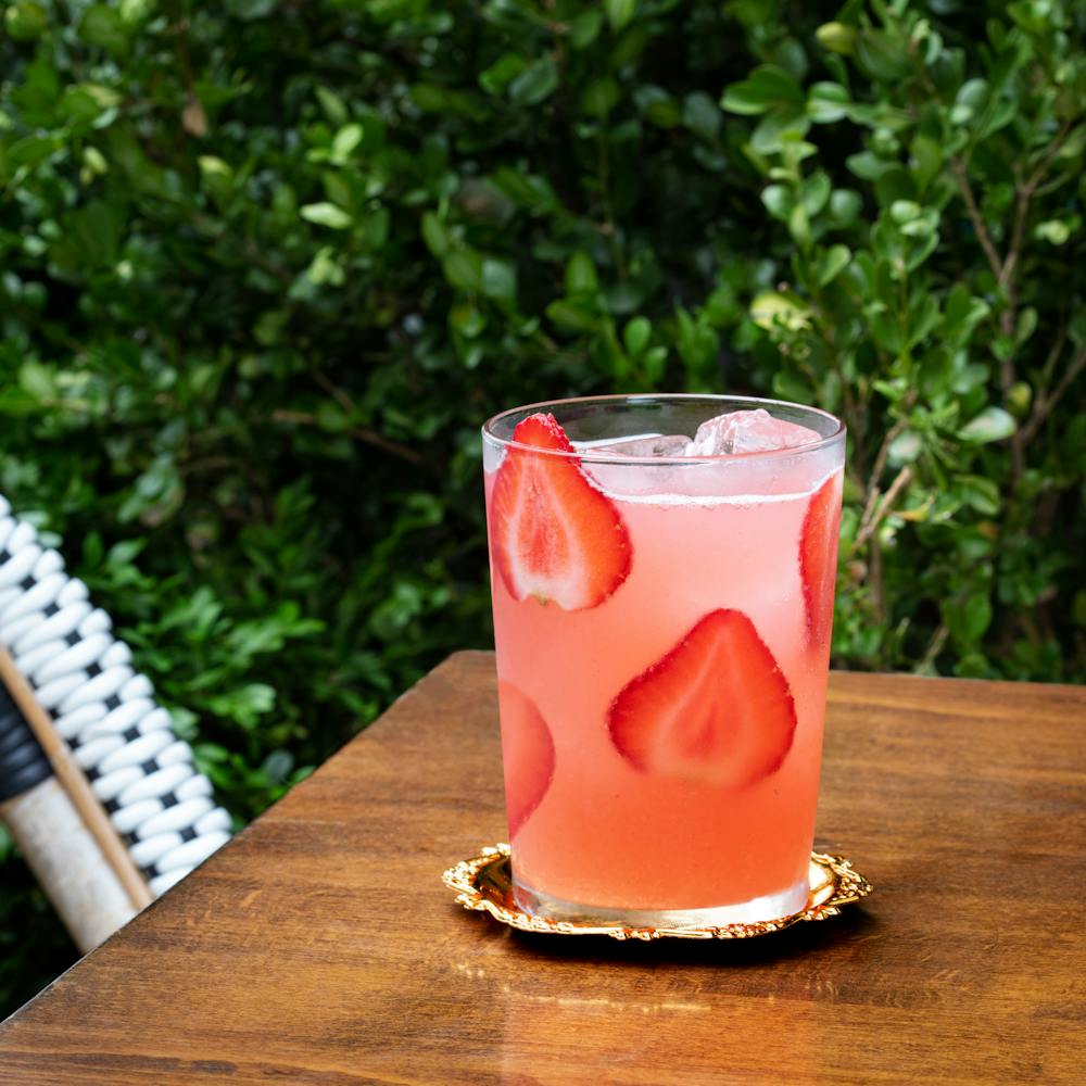 a cup of coffee sitting on top of a wooden table