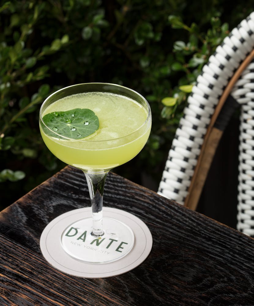 a cup of coffee sitting on top of a wooden table